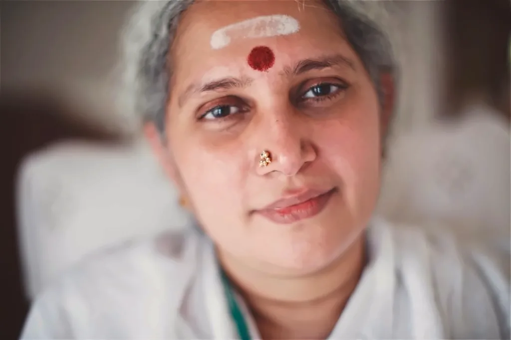 Ganga Maa of Hridaya Kshetram, Tiruvannamalai, in a close portrait with a gentle smile, white vibhuti and a red kumkum mark on her forehead
